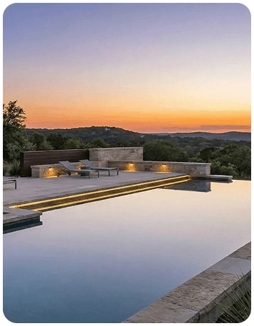 Modern infinity pool overlooking the Texas Hill Country at sunset with elegant landscape architecture and outdoor living design.